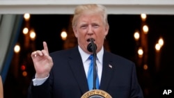President Donald Trump speaks from the Truman Balcony at the Fourth of July picnic for military families on the South Lawn of the White House, July 4, 2017, in Washington. 