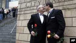 FILE - Terry Gilbert, left, kisses his husband Paul Beppler after wedding at Seattle City Hall, becoming among the first gay couples to legally wed in the state, December 9, 2012. 