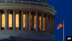 FILE - An American flag flies at the Capitol dome in Washington, July 16, 2019. 