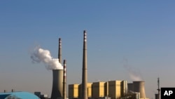 FILE - Smoke billows from a coal-fired power plant in Beijing, China, Nov. 13, 2014.