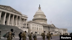 Members of the National Guard arrive at the U.S. Capitol, January 11, 2021, days after supporters of U.S. President Donald Trump stormed the Capitol in Washington.