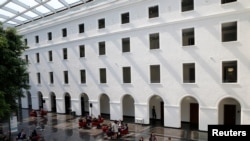 People are pictured in the headquarters of the World Trade Organization in Geneva, Switzerland, April 12, 2017. 