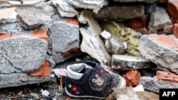 A child’s shoe is seen among the rubble after an explosion at the Shin Kong Mitsukoshi department store in Taichung, Taiwan, on Feb. 13, 2025.