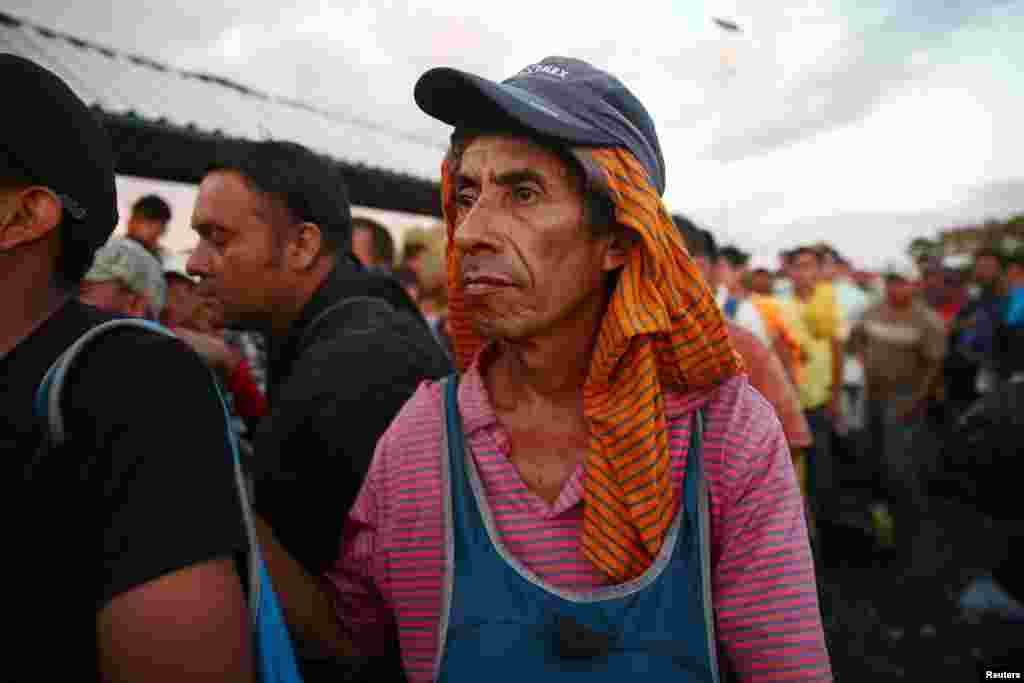 A Central American migrant, part of a caravan trying to reach the U.S., waits on the bridge that connects Mexico and Guatemala to cross into Mexico to continue his trip, in Ciudad Hidalgo, Mexico, Oct. 22, 2018.