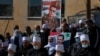 Druse supporters of Syrian President Bashar Assad display display pictures of him during a rally close to the Syrian border demanding the return of the Golan Heights, captured by Israel in 1967, in Majdal Shams, Golan Heights, Feb. 14, 2021.