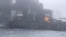 In this image taken from video provided by Denys Mezentsev, rescue crews work on site after a cargo ship was hit by a tanker carrying jet fuel for the U.S. military off eastern England, March 10, 2025, setting both vessels ablaze. (Denys Mezentsev via AP)