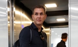 FILE - Szabolcs Dull, editor-in-chief of Hungary's main independent website Index, leaves the newsroom after being sacked in Budapest.