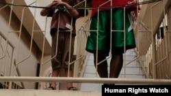 Two asylum-seeking boys stand on a staircase while detained at Belawan Immigration Detention Center, September 2012. (HRW/Kyle Knight photo) 