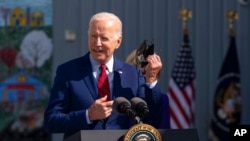 President Joe Biden speaks to school staff during a visit at Brookland Middle School in northeast Washington, Sept. 10, 2021. 
