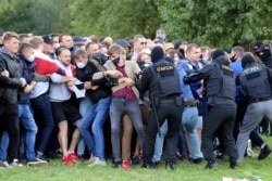Law enforcement officers detain demonstrators during a rally to protest the presidential election results in Minsk, Sept. 13, 2020.