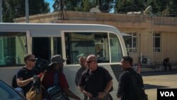 Journalists arrive on the Iraq side of the Syria-Iraq border as Syrian government troops move into areas long-held by Kurdish forces on Oct. 14, 2019 at Pesh Khaboor crossing in the Kurdistan Region of Iraq. (VOA/Yan Boechat)
