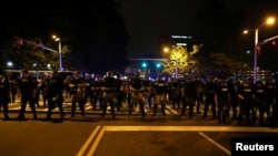 Police in riot gear block a roadway to stop demonstrators from entering a neighborhood as they protest the police shooting of Keith Scott in Charlotte, North Carolina, Sept. 25, 2016.
