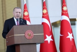 Turkish President Recep Tayyip Erdogan addresses relatives of victims, veterans and citizens after laying flowers at the July 15 Monument during a ceremony marking the Democracy and National Unity Day at the Presidential Complex, July 15, 2021.