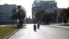 People ride motorcycles on a street empty of traffic near the National Palace in Port-au-Prince, Haiti, July 7, 2021. Gunmen assassinated Haitian President Jovenel Moise and wounded his wife in their home early Wednesday. 
