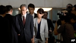 Junichi Ihara, third from left, shakes hand with Song Il Ho, North Korea's ambassador, July 1, 2014.