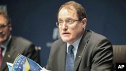 Claudio Sulser, chairman of the FIFA Ethics Committee quotes out of the code of ethics booklet during a press conference at the FIFA headquarters in Zurich, Switzerland, 18 Nov 2010