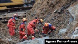 Rescuers work at the scene of a landslide which killed at least 14 people in Bijie, China's southwestern Guizhou province on Jan. 4, 2022.