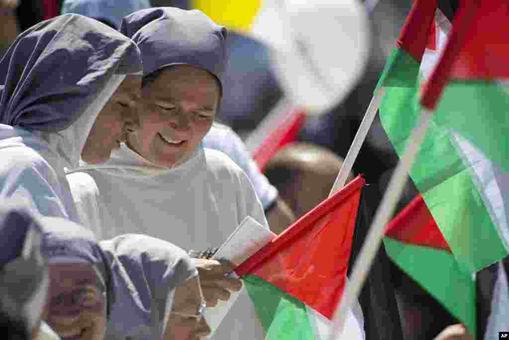 A Greek fisherman rescues a Syrian migrant, right, after his boat stalled while crossing from Turkey to the island of Lesbos, Greece, Sept. 22, 2015. More than 260,000 asylum-seekers have arrived in Greece so far this year, most reaching the country's eastern islands on flimsy rafts or boats from the nearby Turkish coast.