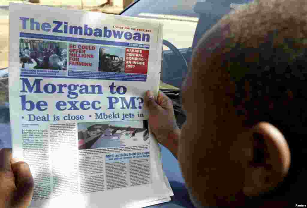 A man reads a local daily newspaper on the street of Zimbabwe's capital Harare August 8, 2008. Zimbabwean President Robert Mugabe and opposition leader Morgan Tsvangirai held make-or-break talks in Harare later that week.&nbsp;