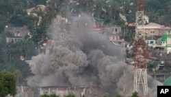 Debris flies as Philippine Air Force fighter jets bomb suspected locations of Muslim militants as fighting continues in Marawi city, southern Philippines, June 9, 2017. 