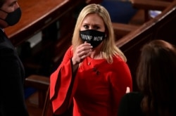 FILE - Marjorie Taylor Greene, a Georgia Republican, wears a "Trump Won" face mask as she arrives to take her oath of office as a newly elected member of the U.S. House, in Washington, Jan. 3, 2021.