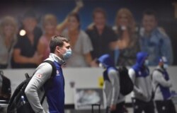 New Zealand Warriors rugby league team players wait to collect their luggage in the arrivals hall after the National Rugby League (NRL) secured an exemption for the team to enter the country, in Tamworth, May 3, 2020.