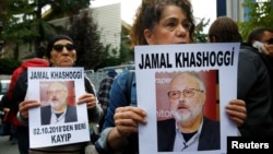 Human rights activists hold pictures of Saudi journalist Jamal Khashoggi during a protest outside the Saudi Consulate in Istanbul, Turkey, Oct. 9, 2018.