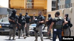 Policemen are deployed during a raid at a hotel near Duroy hotel, where a suicide bomber blew himself up on Wednesday, in Raouche, western Beirut, June 26, 2014. 