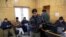 FILE - Kashmiri journalists browse the internet on their mobile phones inside the media center set up by government authorities in Srinagar, Indian controlled Kashmir, January 30, 2020.