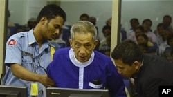 FILE - Kaing Guek Eav, alias Duch, who ran a prison where up to 16,000 people were tortured before being killed, comes before the Khmer Rouge war crimes tribunal in Phnom Penh, Cambodia, March 19, 2012.