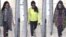 A combination of handout CCTV pictures received from the Metropolitan Police Service shows (L-R) British teenagers Kadiza Sultana, Amira Abase and Shamima Begum passing through security barriers at Gatwick Airport, south of London, on Feb. 17, 2015.