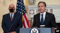 Secretary of State Antony Blinken speaks at the State Department in Washington, Nov. 5, 2021, as Jonathan Moore listens. Moore has been appointed to be the State Department's new coordinator for its investigation into cases of so-called Havana Syndrome. 