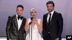 From left, Anthony Ramos, Lady Gaga and Bradley Cooper, nominated for outstanding performance by a cast in a motion picture, introduce a clip from their film "A Star Is Born" at the Screen Actors Guild Awards, in Los Angeles, California, Jan. 27, 2019.