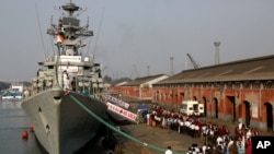 File - Indian school children walk past the visiting Indian Navy warship INS Kirch for a guided tour in Kolkata, Dec. 5, 2019. India is sending four navy ships for exercises and port visits in the Indo-Pacific region as China's maritime power grows.