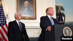 President Donald Trump speaks about the shootings in El Paso and Dayton as Vice President Mike Pence looks on in the Diplomatic Room of the White House in Washington, Aug. 5, 2019.