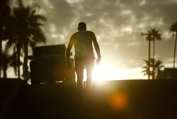 A man makes his way up a hill following his morning beach workout in California, America's largest state, which experienced the lowest growth rate in its history between 2010 and 2020.