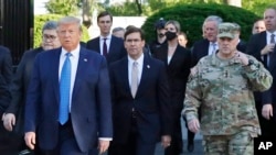FILE - In this June 1, 2020 file photo, President Donald Trump departs the White House to visit outside St. John's Church, in Washington. Walking behind Trump, Secretary of Defense Mark Esper and Gen. Mark Milley, chairman of the Joint Chiefs of Staff. 