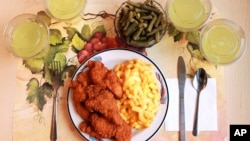 This undated photo provided by the National Institutes of Health in June 2019 shows an "ultra-processed" lunch including brand name macaroni and cheese, chicken tenders, canned green beans and diet lemonade. (Paule Joseph, Shavonne Pocock/NIH via AP)