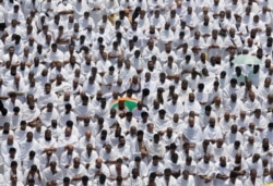 Hundreds of thousands of Muslim pilgrims pray outside Namira Mosque in Arafat during the annual hajj pilgrimage, near the holy city of Mecca, Saudi Arabia, Saturday, Aug. 10, 2019.