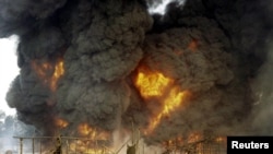 FILE - Nigeria's amnesty program for ex-militants was begun in 2009 to stop the sabotage of oil facilities, like this attack on a pipeline in Andoni in December 2005. Recent attacks have raised fears of renewed militancy in the area. 