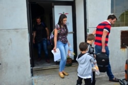 Lucia Ascencio of Venezuela, her husband and their two sons, arrive back to Nuevo Laredo, Mexico, as part of the first group of migrants to be returned to Tamaulipas state as part of a program for U.S. asylum-seekers, July 9, 2019.
