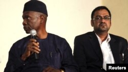 Francis Ogboro (L) and Suhail Farooqui, representatives of Dana Air, attend a news conference at Lagos State University Teaching Hospital, June 6, 2012. 