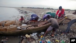 Fishermen remove their wooden boat from the sea as a precaution against Hurricane Irma, in the seaside slum of Port-au-Prince, Haiti, Sept. 6, 2017. The northern parts of the Dominican Republic and Haiti could see 10 inches of rain.