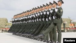 Soldiers of China's People's Liberation Army march with their weapons during a training session for a military parade to mark the 70th anniversary of the end of World War II, at a military base in Beijing, Sept. 1, 2015. 
