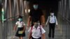 FILE - Students wearing face masks to prevent the spread of Covid-19 coronavirus walk on an overpass on their way to school in Phnom Penh on February 1, 2021.