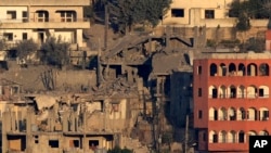 Houses lie in ruin in Khiam, a town near the Lebanese-Israeli border that was hit by Israeli air strikes on June 21, 2024, as seen from the Lebanese town of Marjayoun on June 22. 