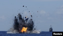 FILE - The Indonesian navy scuttles foreign fishing vessels caught fishing illegally in Indonesian waters near Bitung, North Sulawesi, May 20, 2015.