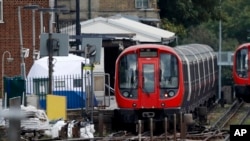 A police forensic tent stands on the platform next to the train on which a homemade bomb exploded at Parsons Green subway station in London, Sept. 15, 2017.