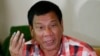 Front-running presidential candidate Mayor Rodrigo Duterte gestures during his second news conference after voting in a polling precinct at Daniel R. Aguinaldo National High School, Matina district, his hometown in Davao city in southern Philippines, May