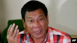 Front-running presidential candidate Mayor Rodrigo Duterte gestures during his second news conference after voting in a polling precinct at Daniel R. Aguinaldo National High School, Matina district, his hometown in Davao city in southern Philippines, May